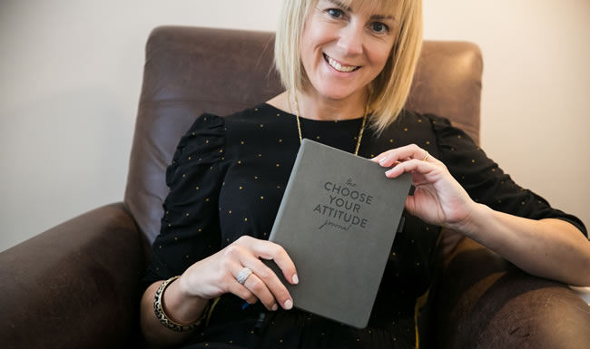 Debra Searle holding the Choose Your Attitude journal